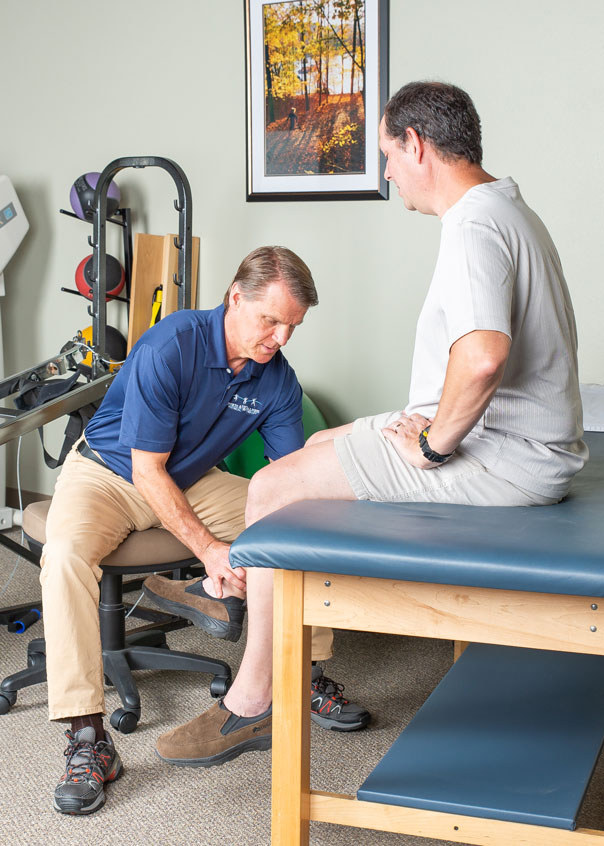 Doctor looking at patient's ankle